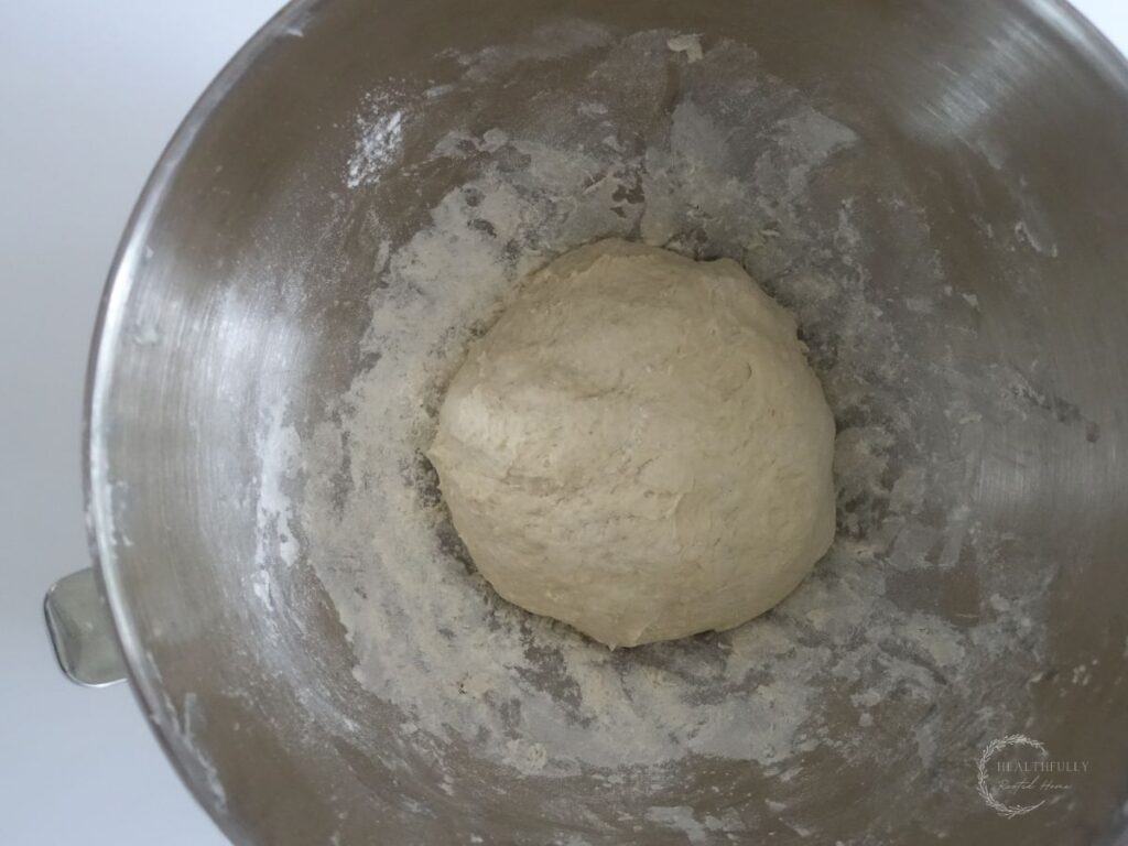 dough for sourdough discard focaccia bread in the bowl of a stand mixer prior to the first rise.