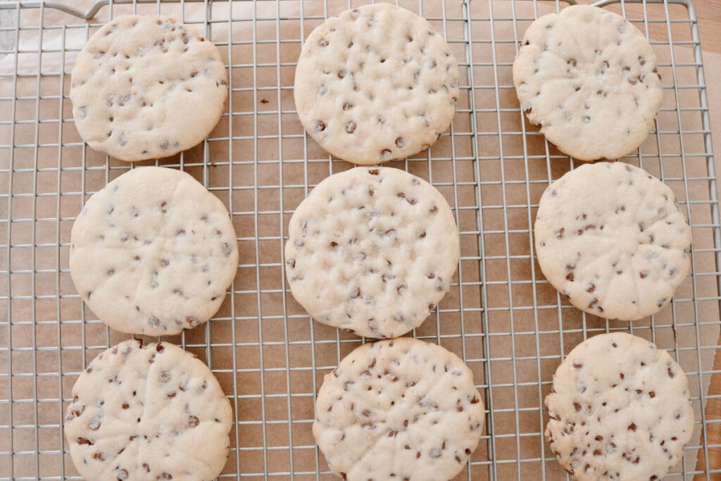 baked chocolate chip sugar cookies on a wire cooling rack