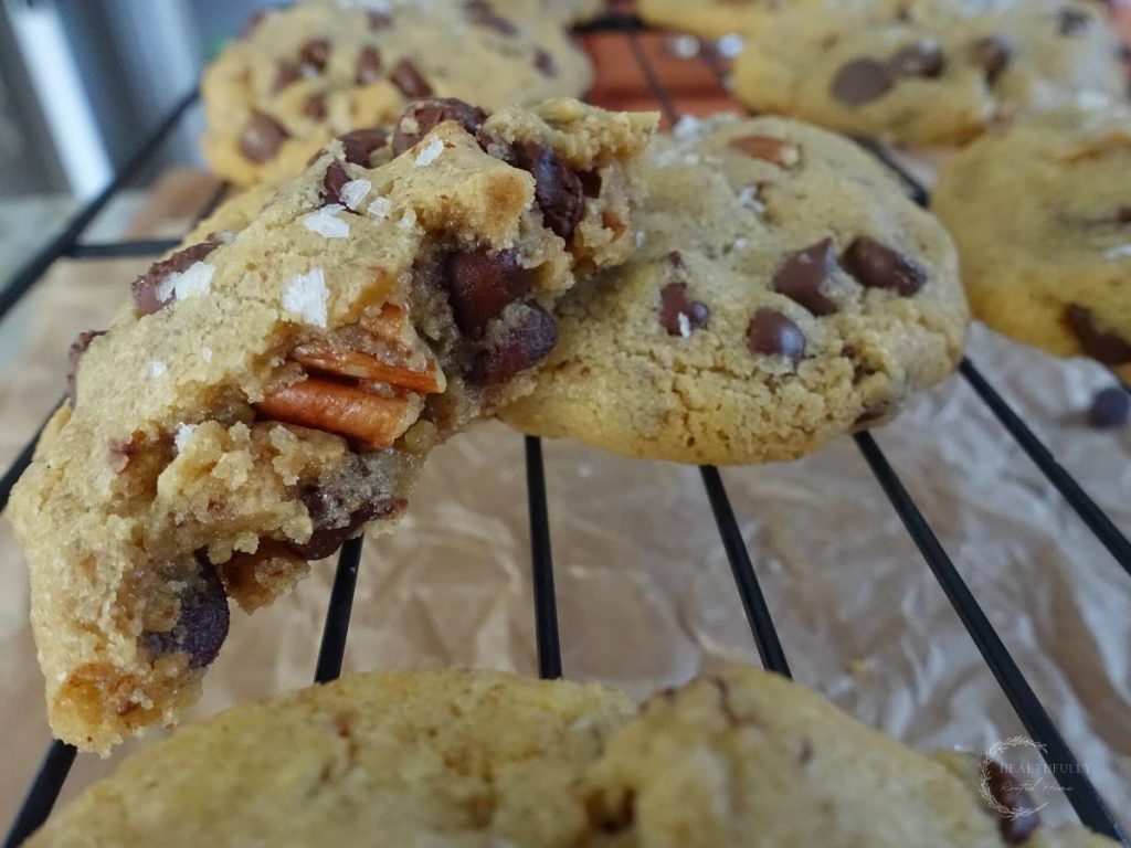 cookies from scratch with one chocolate chip cookie cut in half on a wire cooling rack