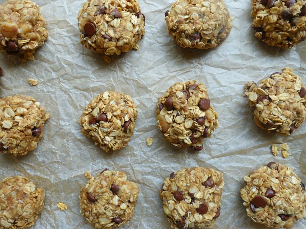 4 ingredient oatmeal cookies on a baking sheet after being baked lined in rows