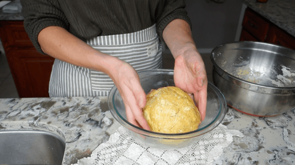 healthfully rooted home pumpkin sourdough cinnamon roll dough shaped and placed in greased glass bowl