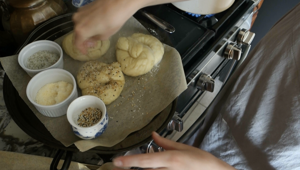 sourdough pretzels after being boiled adding toppings like everything bagel seasoning parmesan cheese and sea salt