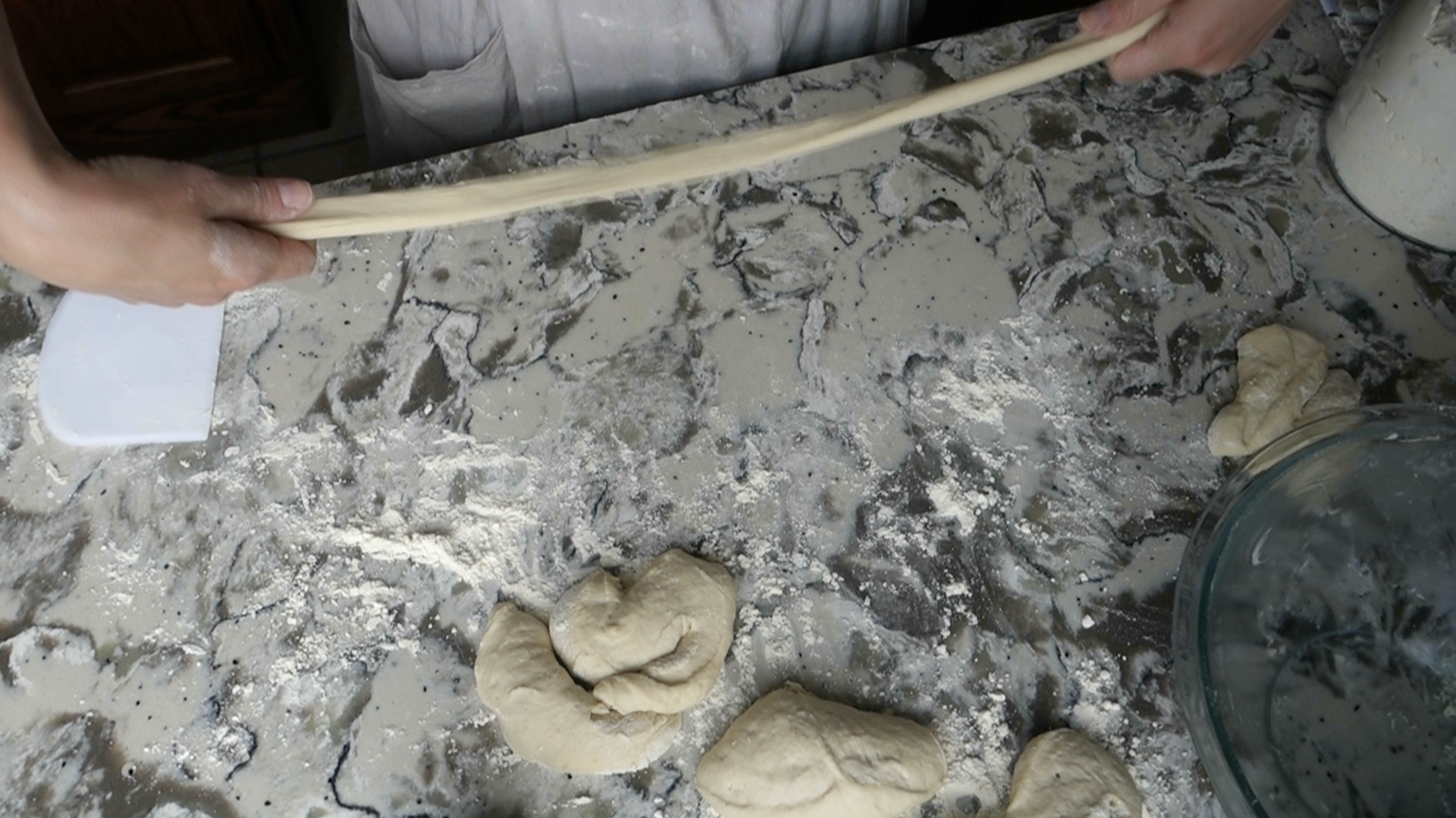 stretching long fermented sourdough pretzel dough