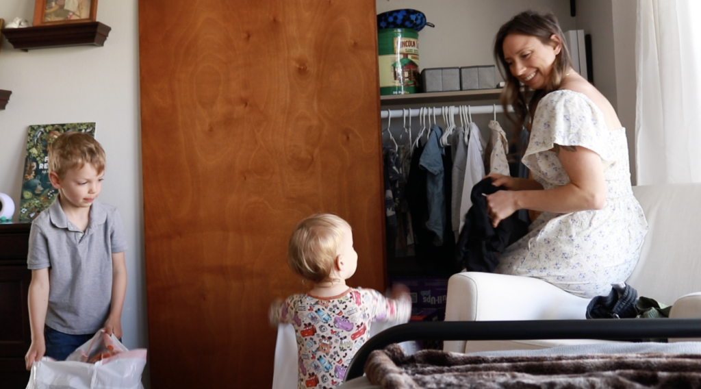 A Christian homemaker helps her son sort clothes.