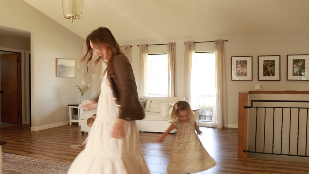 A Christian homemaker and her daughter spin and twirl in circles in lovely dresses.
