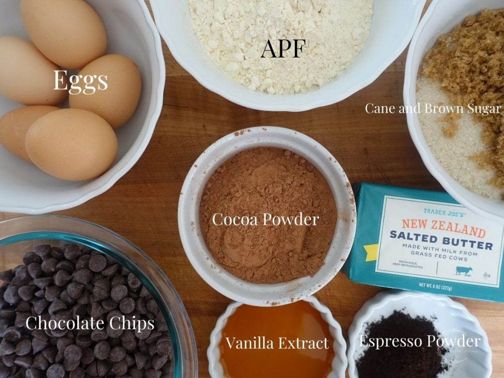 ingredients in white bowls with labels for what they are