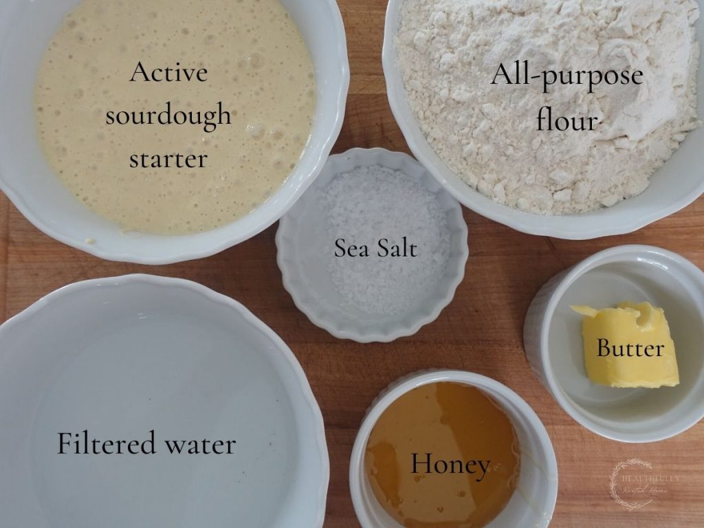 ingredients to make long fermented sourdough pretzels. all ingredients are in white bowls and have labels saying what they are