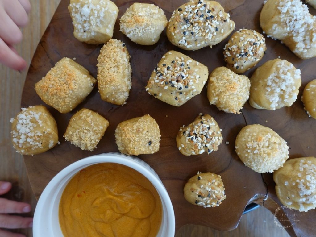 sourdough pretzel bites with toddler hands reaching for one
