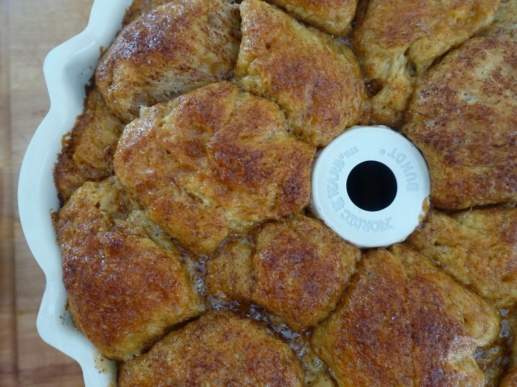 sourdough monkey bread in a bundt pan after being baked with a golden brown top