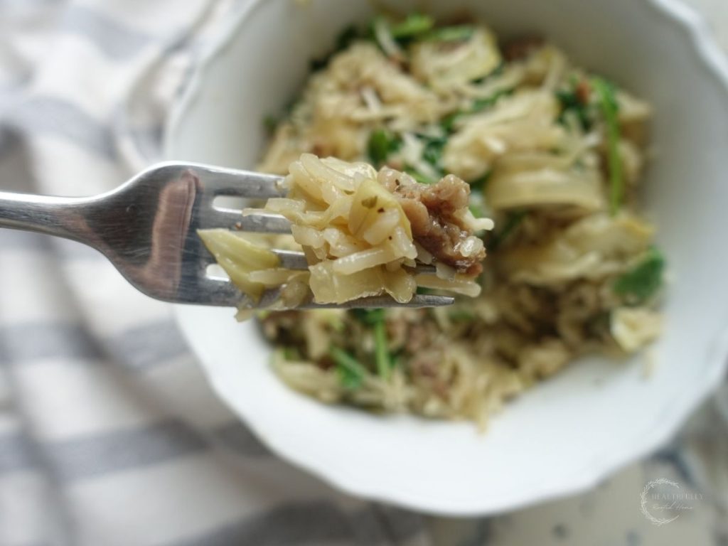 risotto basmati in a white bowl with a bite on a fork