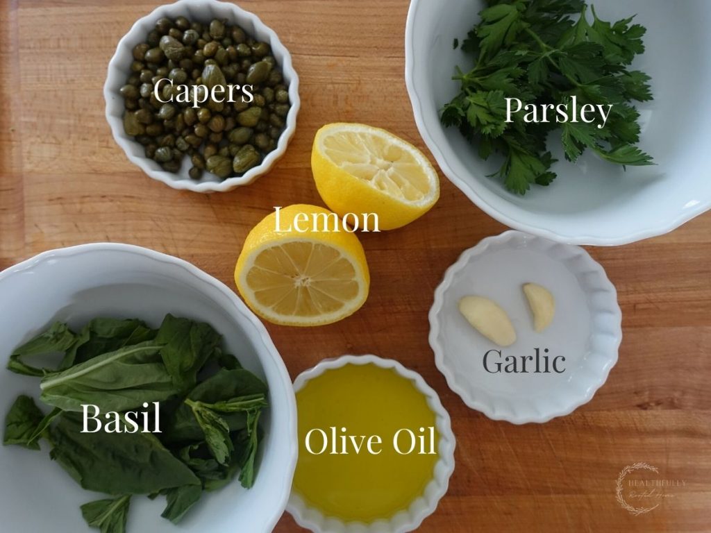 ingredients for salsa gremolata in white jars with labels for what they are