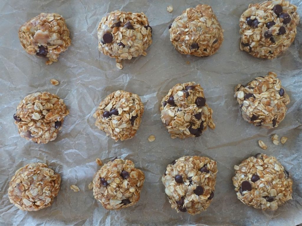 shaped 4 ingredient oatmeal cookies on a baking sheet ready for baking