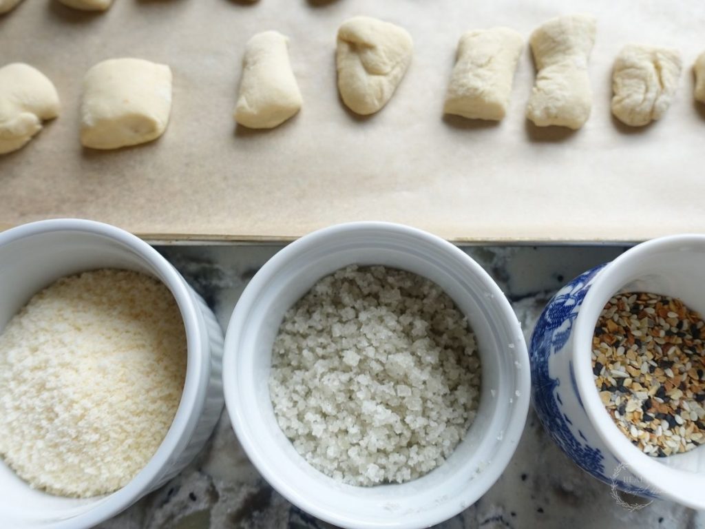 topping ideas for sourdough pretzel bites lined up in a row next to the pretzel bite dough