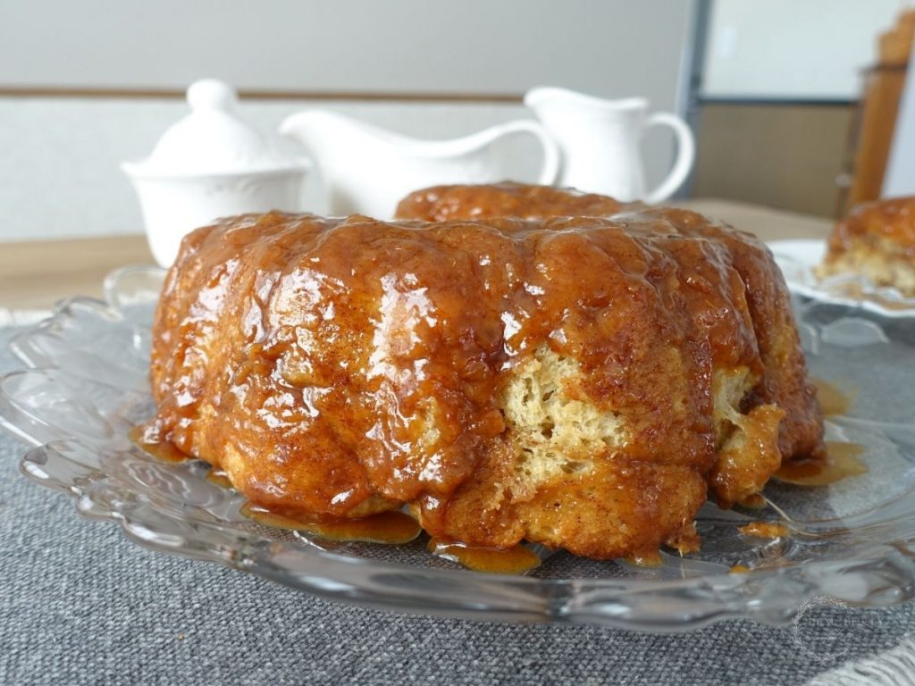 sourdough monkey bread on a serving platter ready to be served with white vintage jars behind it