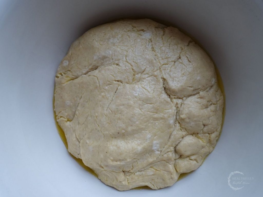 sourdough monkey bread dough after proofing at room temperature in a ceramic bowl