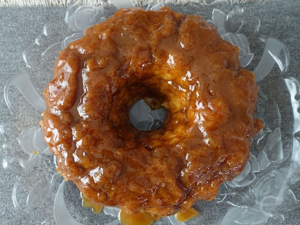 sourdough monkey bread on a serving platter with salted caramel sauce dripping off of it