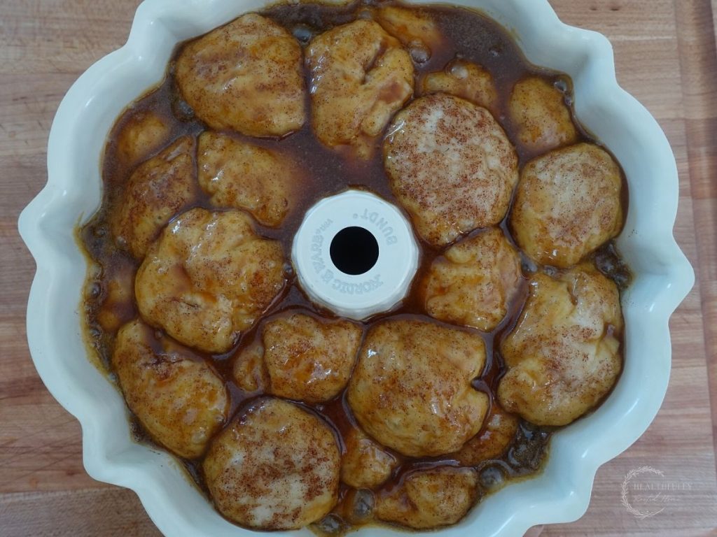 salted caramel sauce poured overtop sourdough monkey bread dough after it's final rise