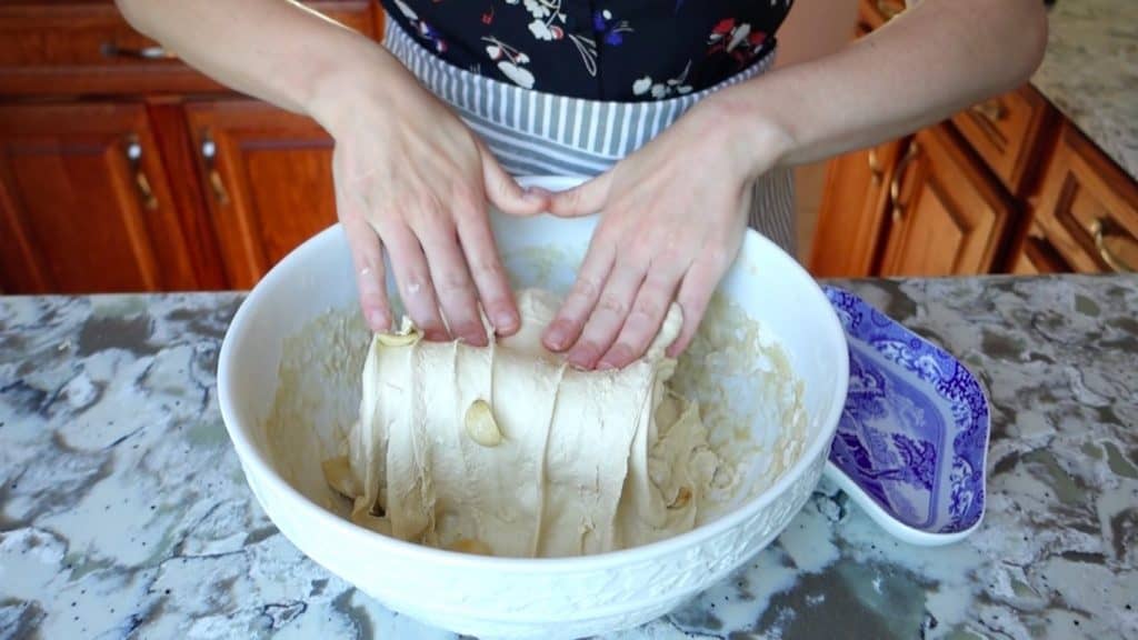 stretch and fold process folding over with garlic cloves peaking out